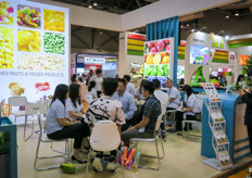 Negotiations at the stand of the Shandong Taifeng Commercial Group, a grower and exporter of Chinese fruits and vegetables.